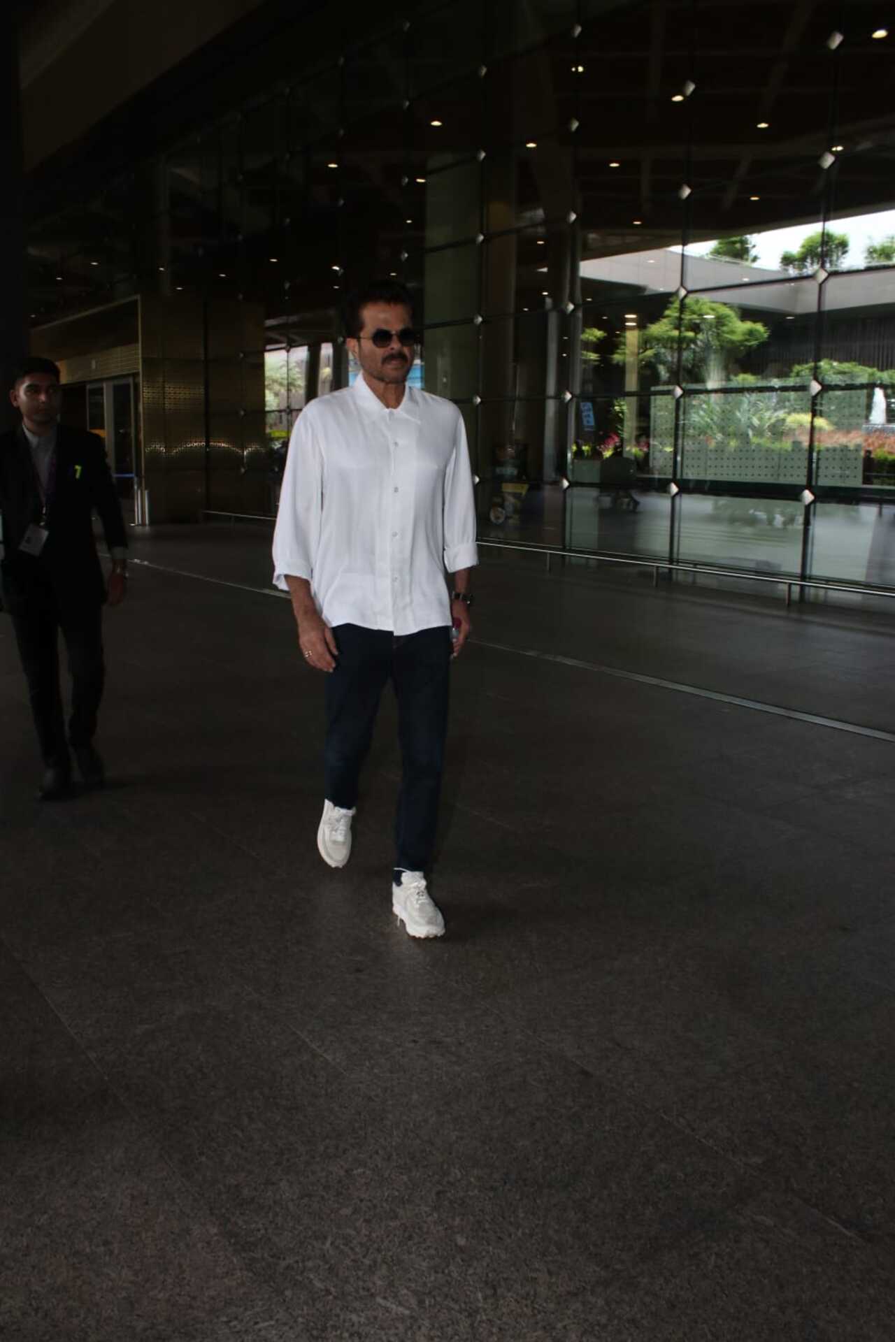 He was clicked at the airport in a white shirt and pants